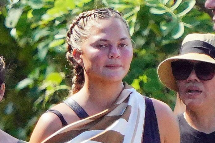 Make an unconventional hiking gear with Chrissy Teigen's Bathing Suit & Sleek Sneakers.