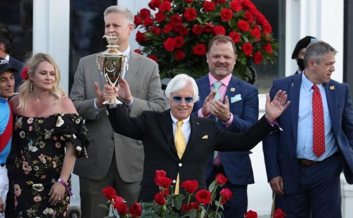 Bob Baffert holds up the winner’s trophy Bob Baffert holds up the winner’s trophy
