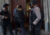 outside the Indonesian Presidential Palace, a gun-wielding woman was detained